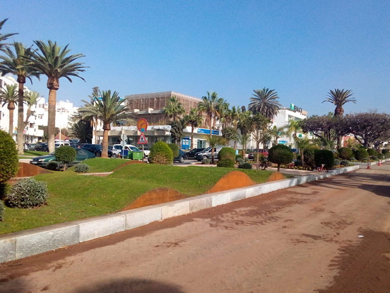 Aménagement paysager urbain avec bordures en acier Corten, pelouses, palmiers et végétation à Agadir