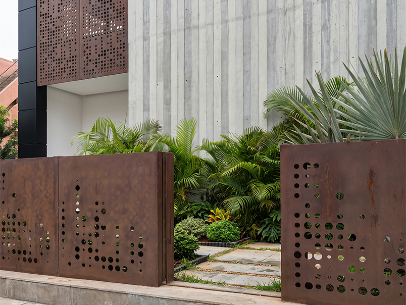 Entrée du siège Anfa Realties avec panneaux de clôture en acier Corten perforé et végétation